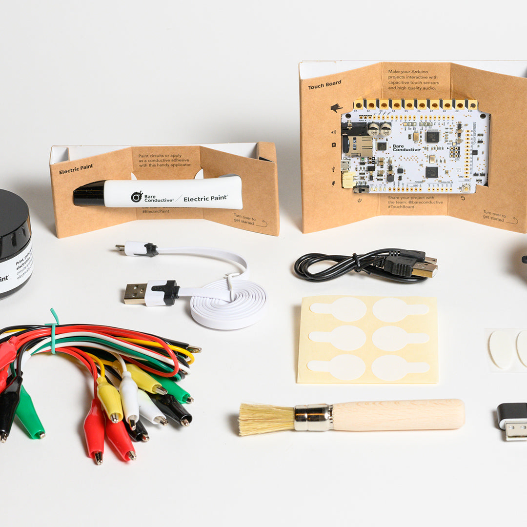 BARE Touch Board Starter Kit - Full view of inside content includes: 10 ml and 50 ml pot of electric paint, brush, cable testers, mini aligator lead cable set, two usb cable, mother board among others.