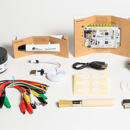 BARE Touch Board Starter Kit - Full view of inside content includes: 10 ml and 50 ml pot of electric paint, brush, cable testers, mini aligator lead cable set, two usb cable, mother board among others. 